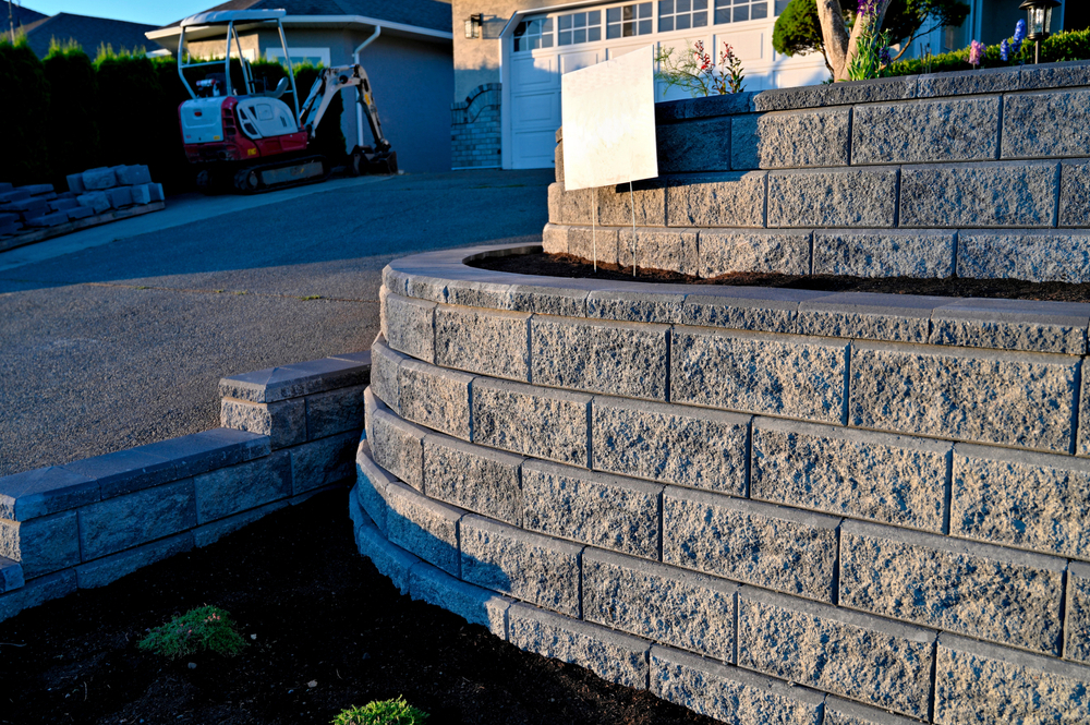 Tiered retaining walls beside a residential driveway in Orange County, CA