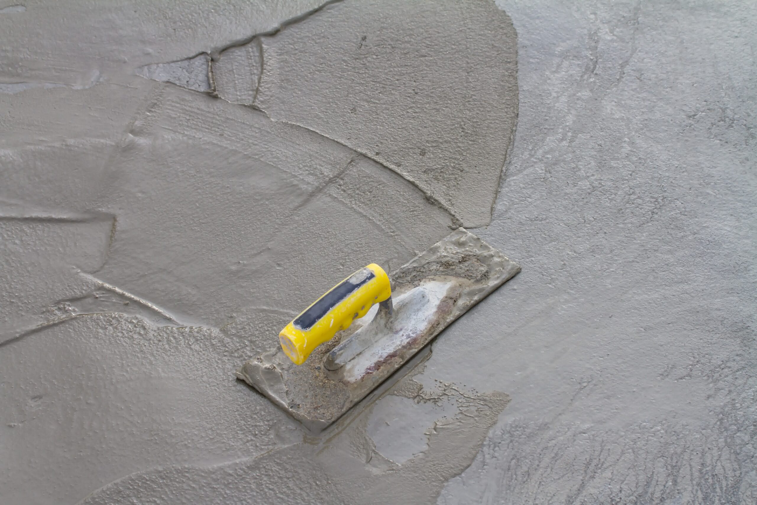 Up close shot of concrete being smoothed out.