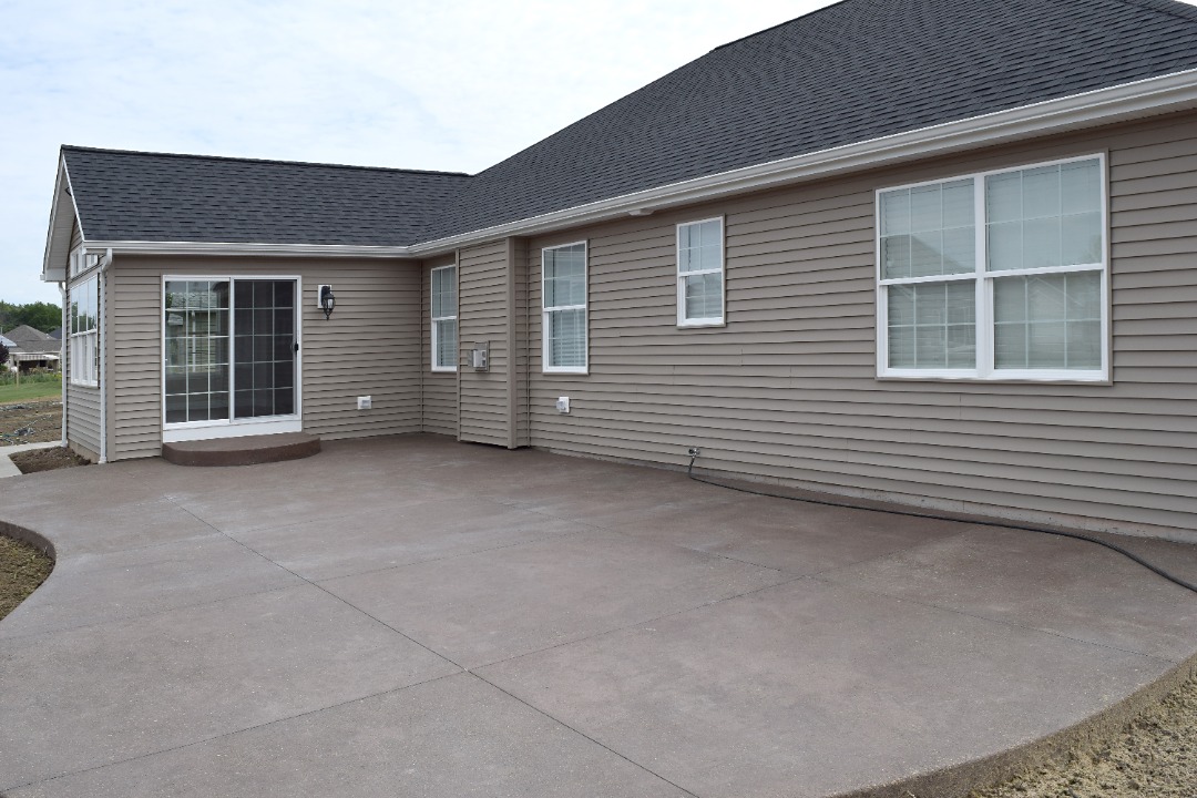 Empty outdoor patio with concrete flooring, ideal candidate for resurfacing or concrete demolition and new installation.